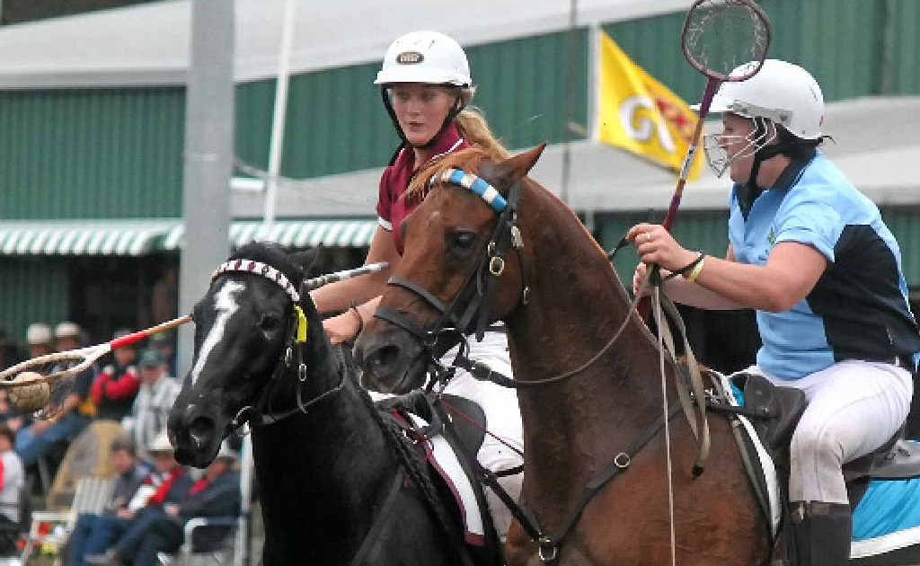 Dual award winner Ryle Waugh, of Queensland, (left), in possession against NSW star Sally Thompson in the under-24 final which the Blues won 19-18.